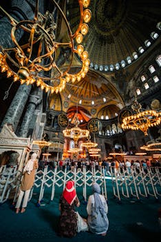 Captivating view inside Istanbul's Hagia Sophia Mosque with ornate chandeliers.