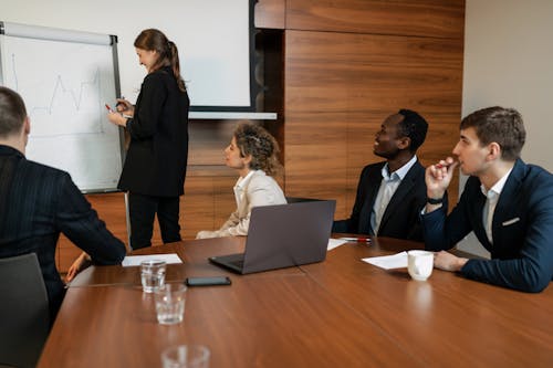 Free Man in Black Suit Sitting beside his Colleagues Stock Photo