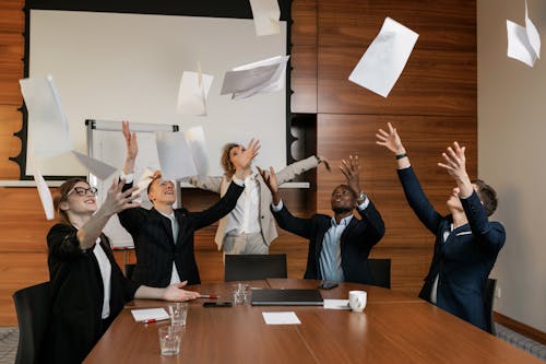 Free People in Business Suit Throwing White Papers Stock Photo
