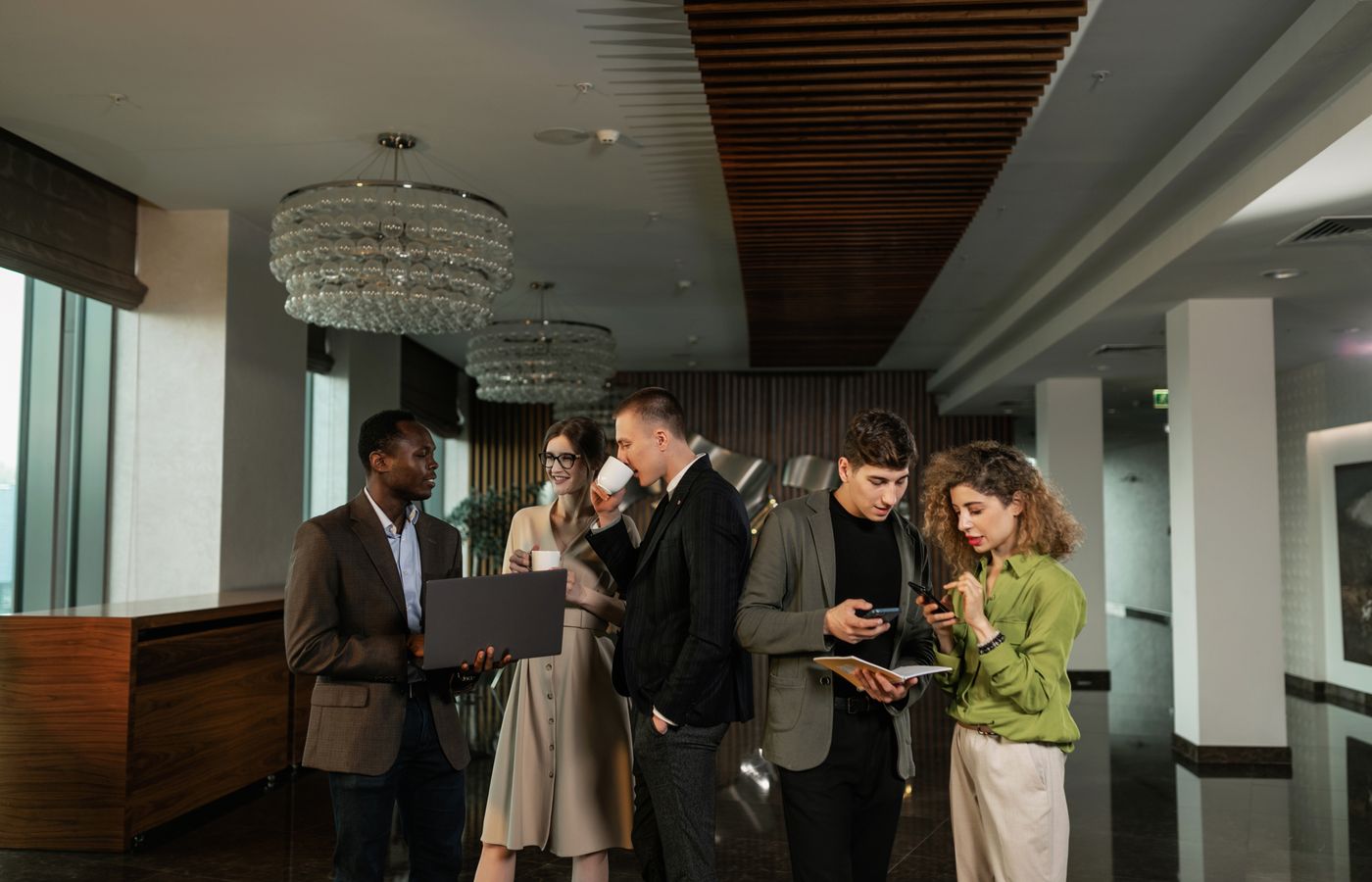 A diverse group of professionals discussing plans in a modern office setting.