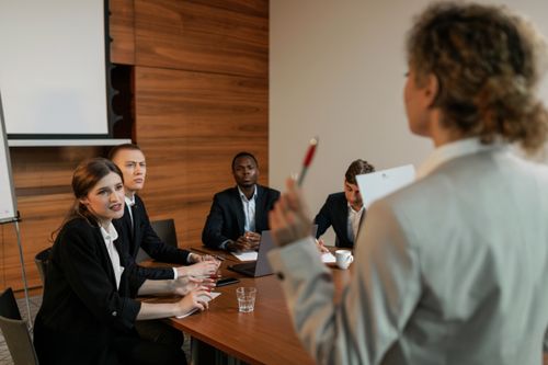 Free Professional business discussion among diverse colleagues in a modern office setting. Stock Photo