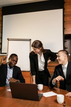 A diverse group of professionals engaged in teamwork during a business meeting.
