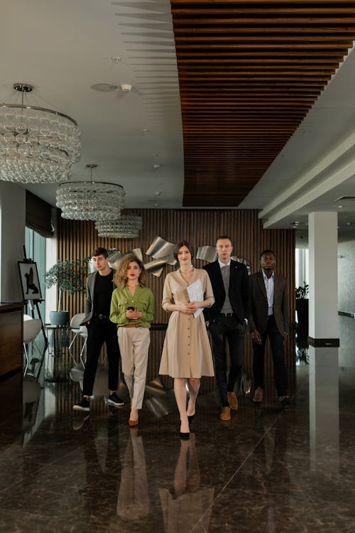 Free Women Walking with Men at the Office Stock Photo