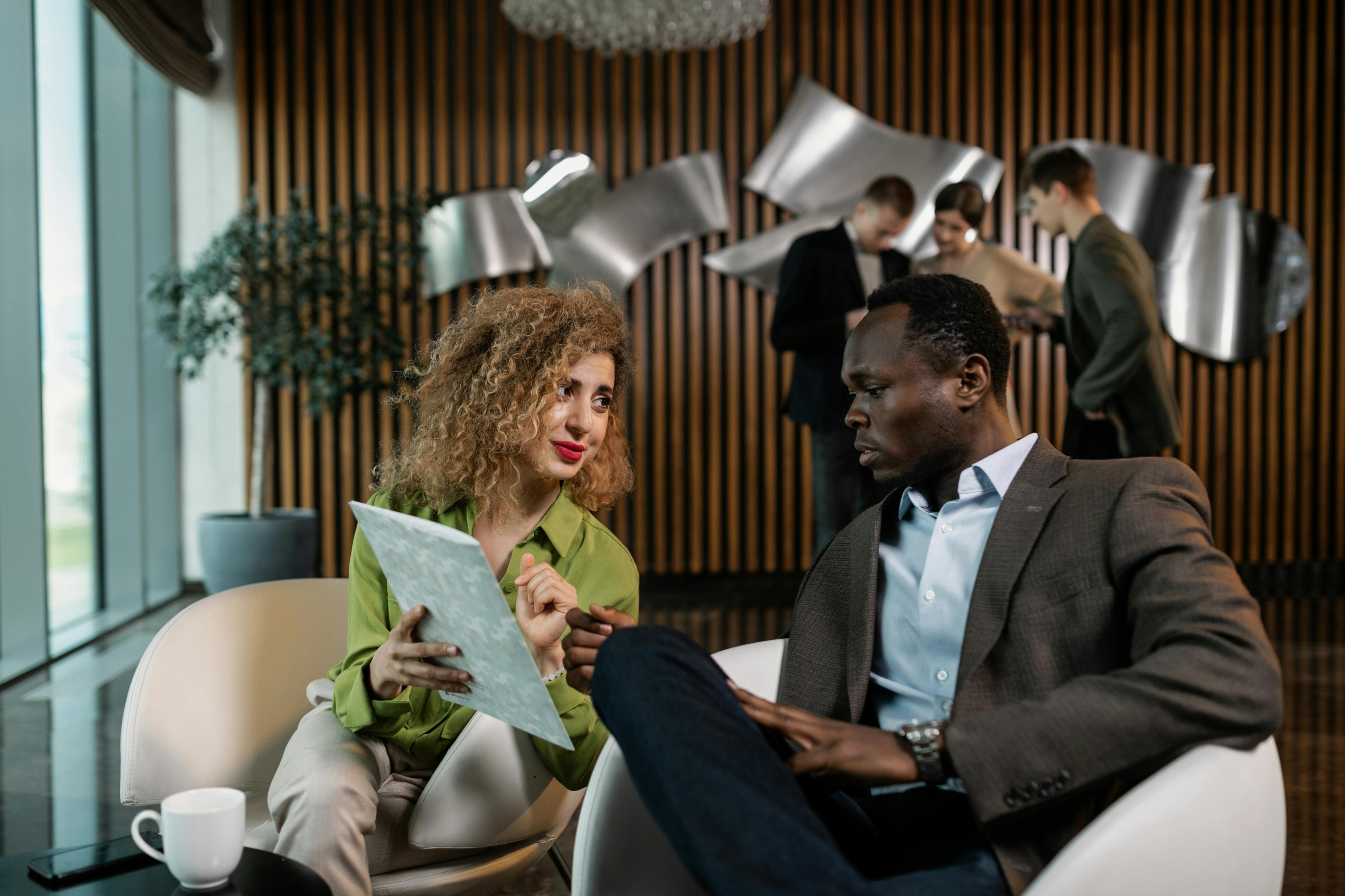 man and woman having a discussion at the office