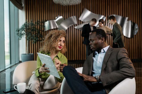 Free Man and Woman Having a Discussion at the Office Stock Photo