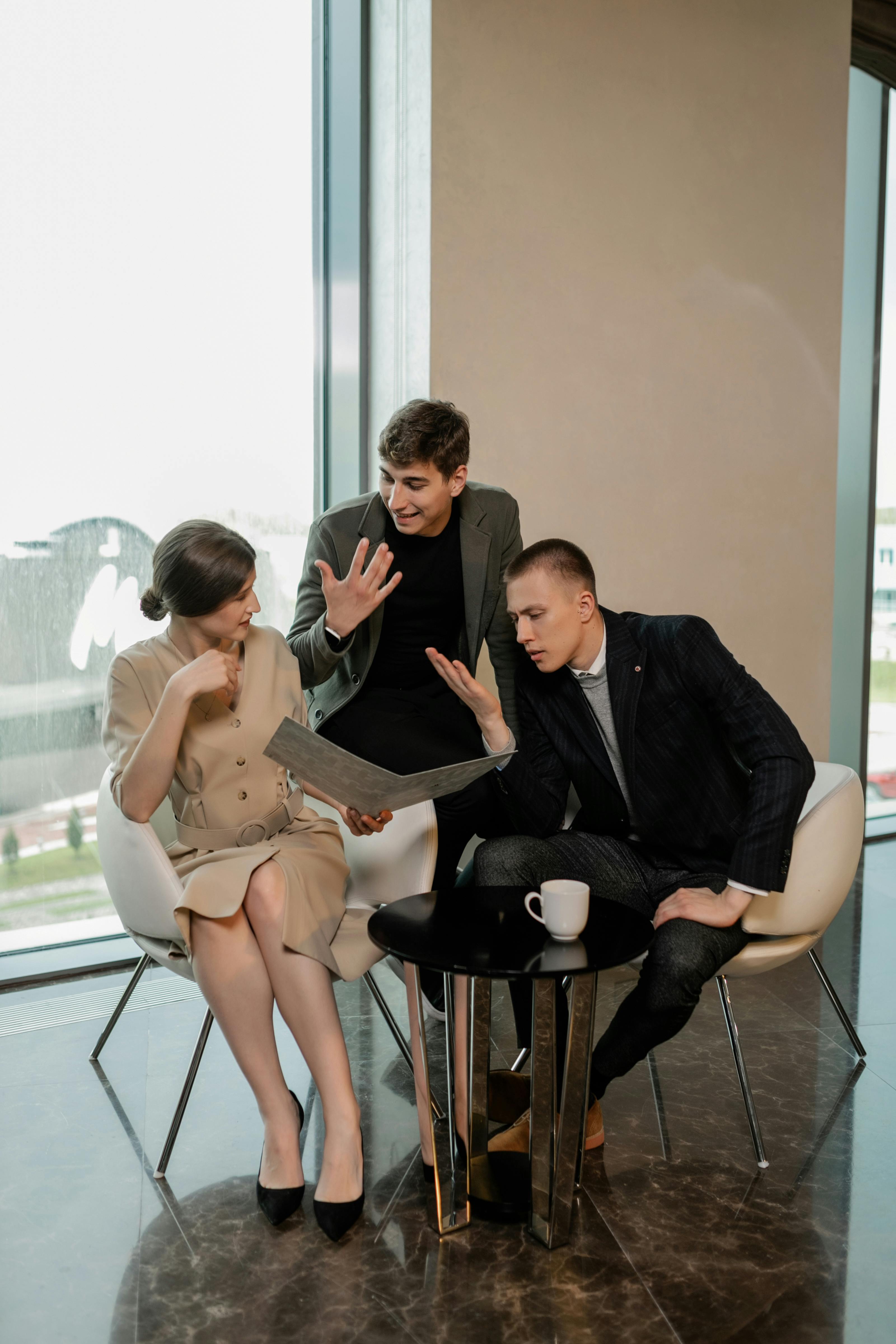 woman in brown dress holding a folder while talking to men