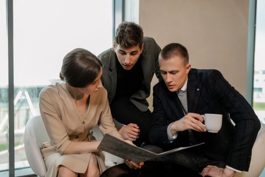 Young professionals engaging in a collaborative business discussion in a modern office setting.