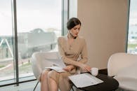 A Woman Having Coffee while Looking at a Document