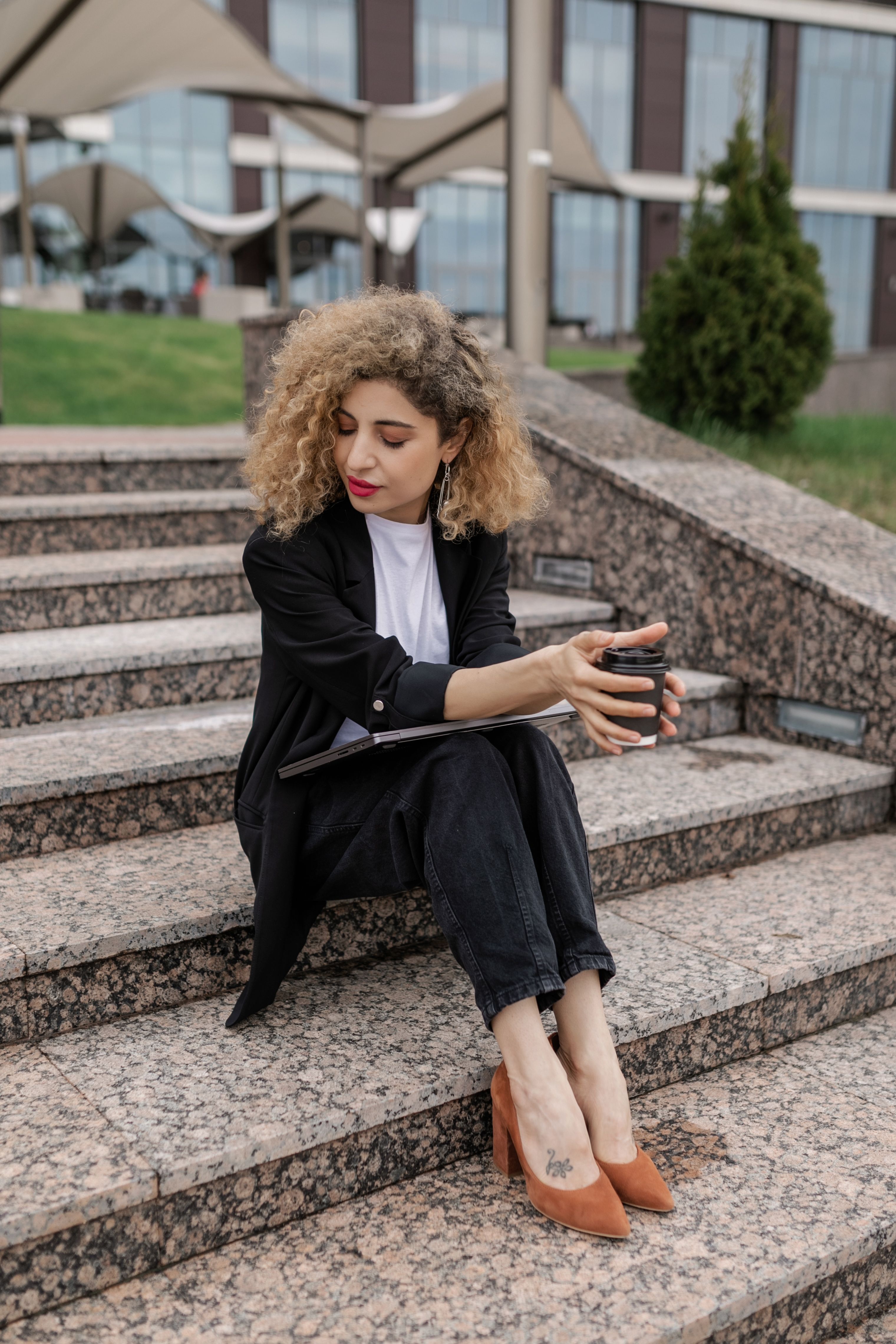 A Woman in Black Blazer and Pants Sitting on the Stairs · Free Stock Photo