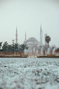 Captivating winter scene of the Hagia Sophia in Istanbul, surrounded by snow and a soft misty ambiance.