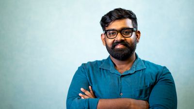 Portrait of a smiling Indian man with glasses