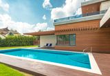 Backyard swimming pool under a blue sky