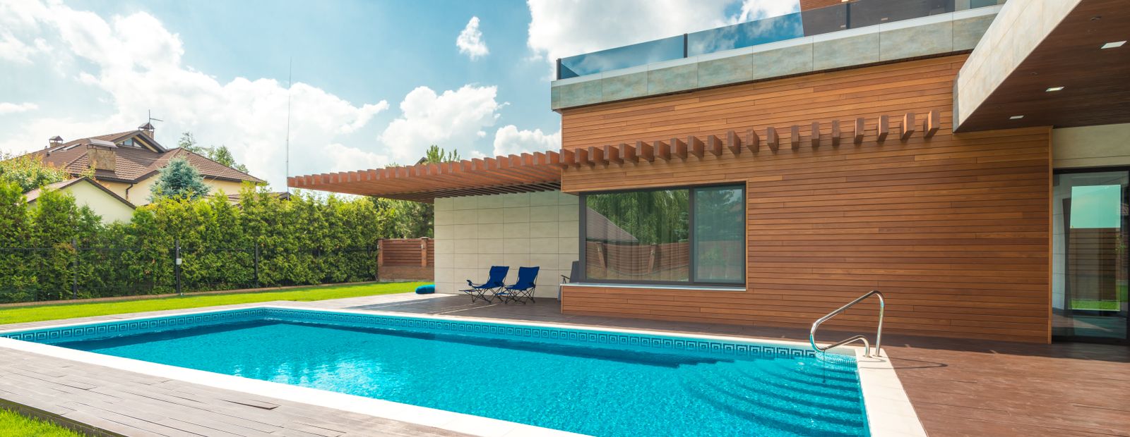 Backyard swimming pool under a blue sky