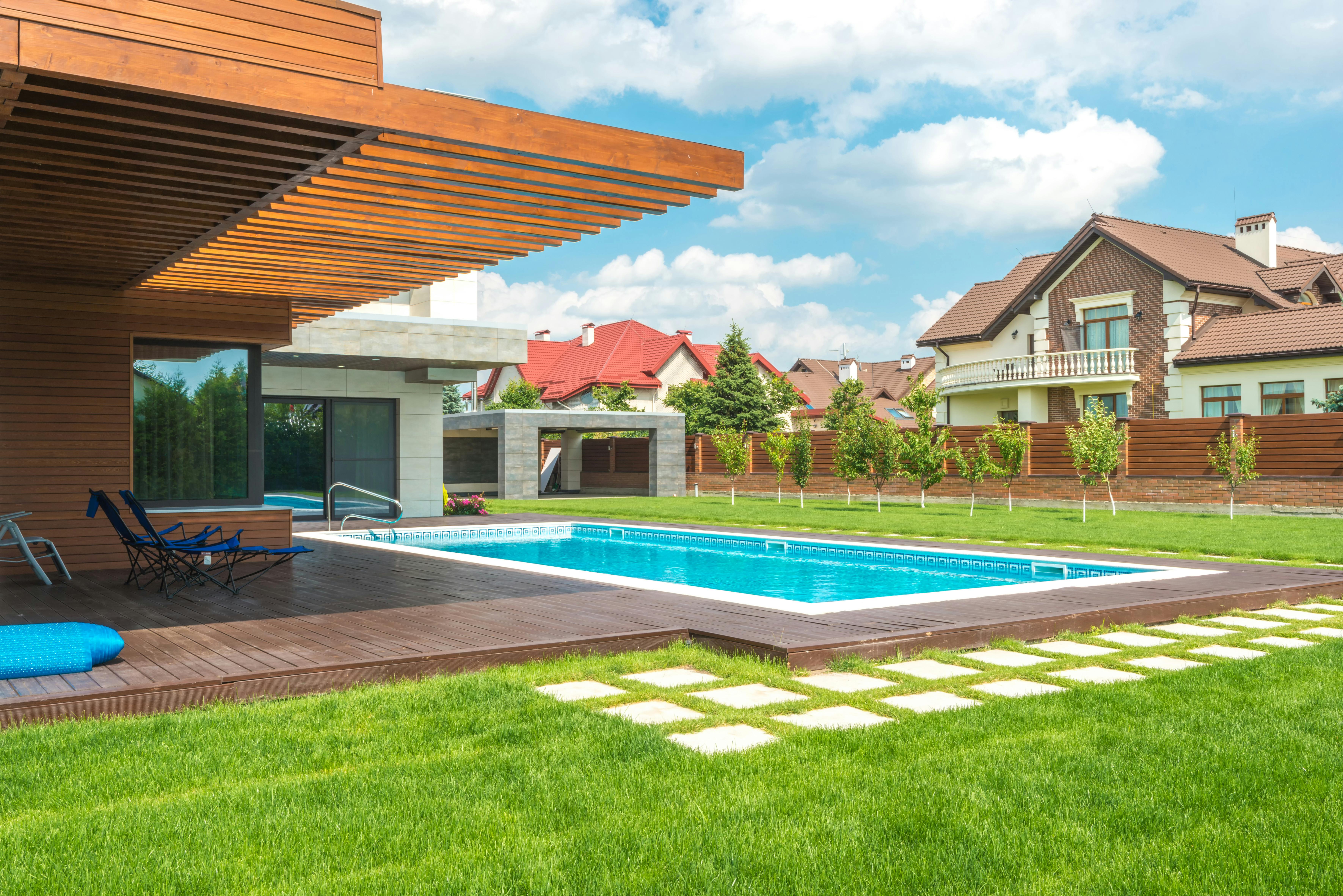 Turf surrounding a swimming pool in a yard
