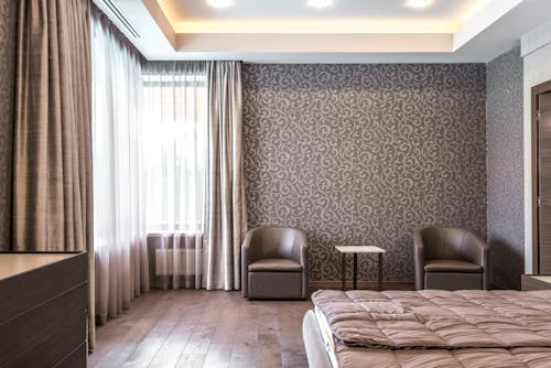 Bedroom with Wallpaper and Wooden Floor