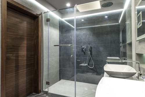 Interior design of a walk in bathroom with handheld shower and ceiling shower