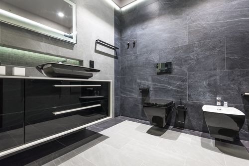 Free Luxurious modern bathroom featuring sleek grey tiles and minimalist design elements. Stock Photo