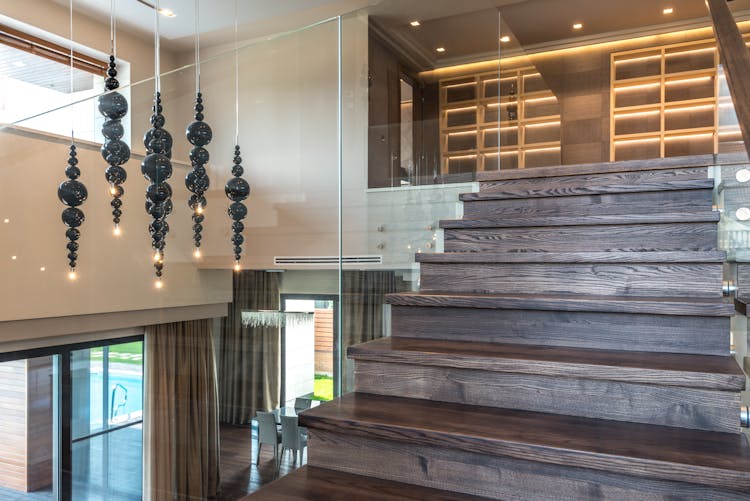 Brown Wooden Staircase With Glass Railing