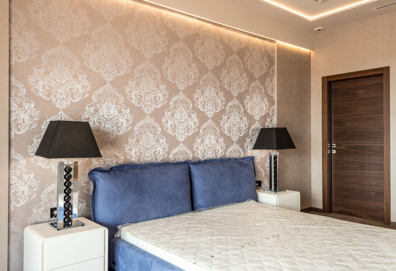 Wallpapering in Luxted — clean edges cut in around trim and sockets