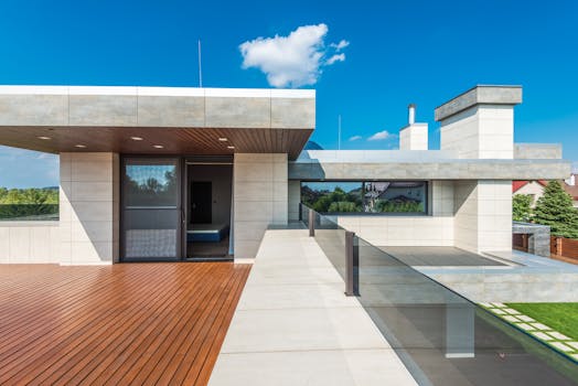 Sleek modern terrace featuring wood decking and blue sky background.