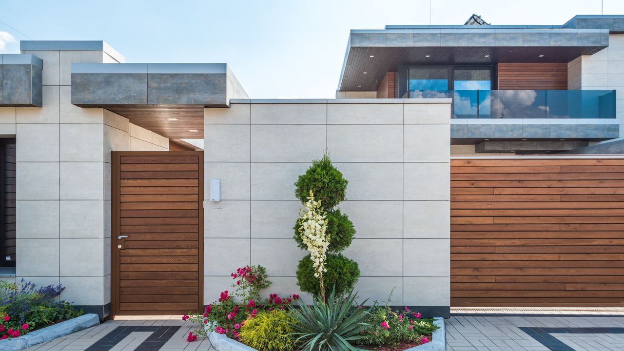 The front of a house with its beds, borders and planting finished