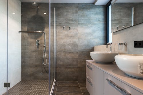 A Ceramic Sink on Top of the Drawer Near the Shower Room