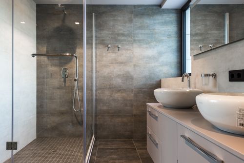 Free Stylish bathroom interior featuring ceramic sinks, glass shower, and elegant finishes. Stock Photo