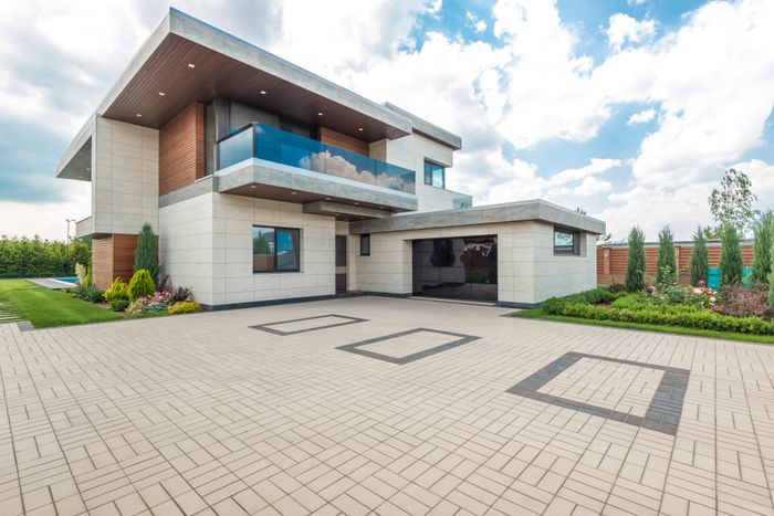 Modern home exterior with tall windows and a paved forecourt, photo by Max Vakhtbovych on Pexels