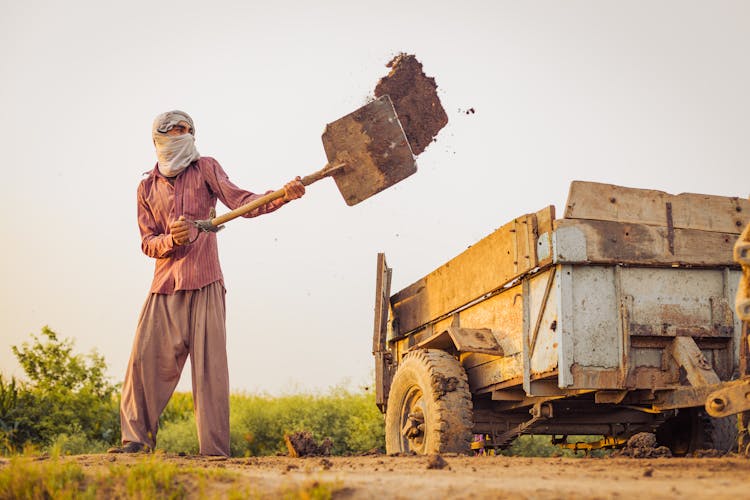 A Man Shoveling Soil