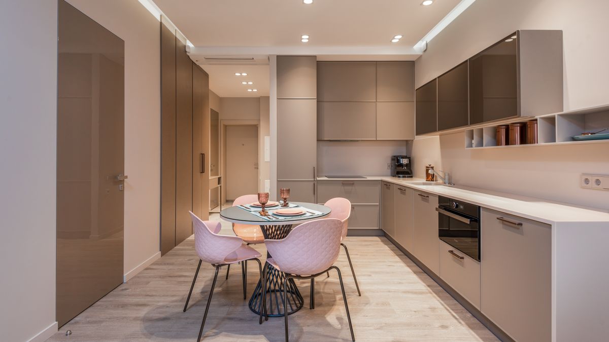 A fitted kitchen with a round dining table and four chairs, the kind of space a crew gets in serviced accommodation