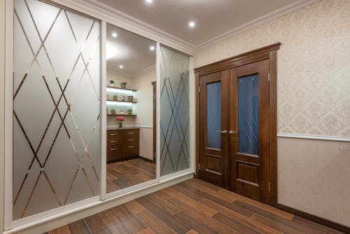 A Wooden Door Near the Mirror
