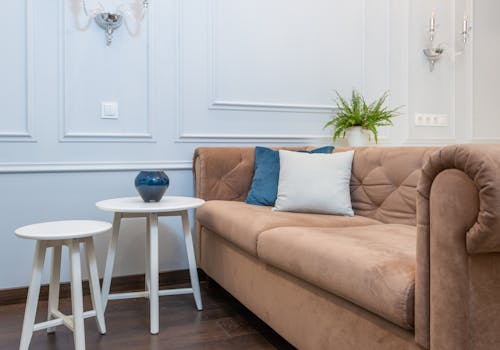 A Cozy Couch Near the White Table and Chair on a Wooden Floor