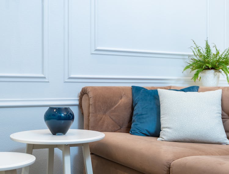 Sofa With Cushions And White Round Coffee Tables