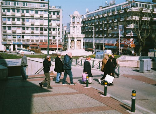 Group of People Crossing Street in City