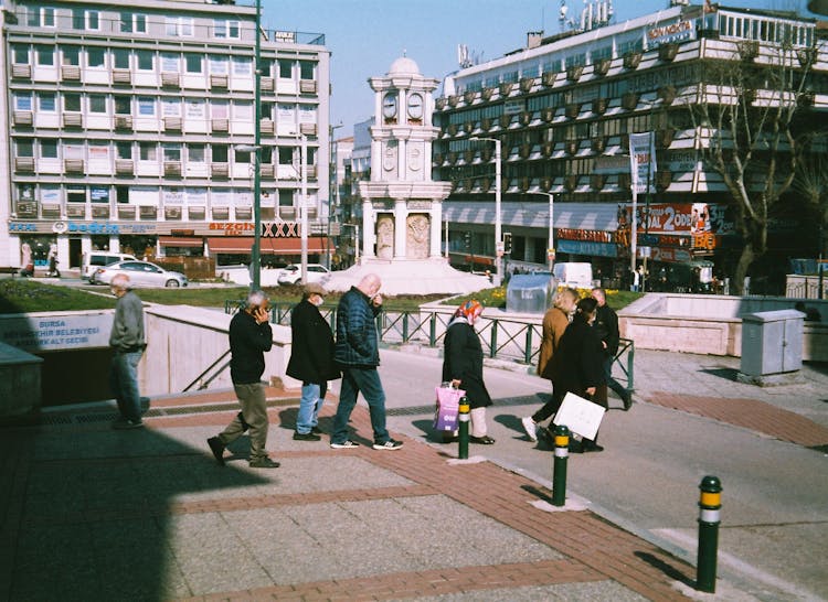 Group Of People Crossing Street In City