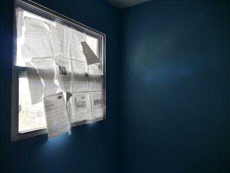 Window in Room Covered with Paper Sheets