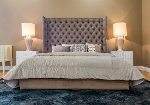 Upscale bedroom with plush bedding and ambient lighting for a cozy and inviting atmosphere.
