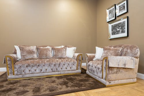 A Velvet Couches with Brown Carpet on a Wooden Floor