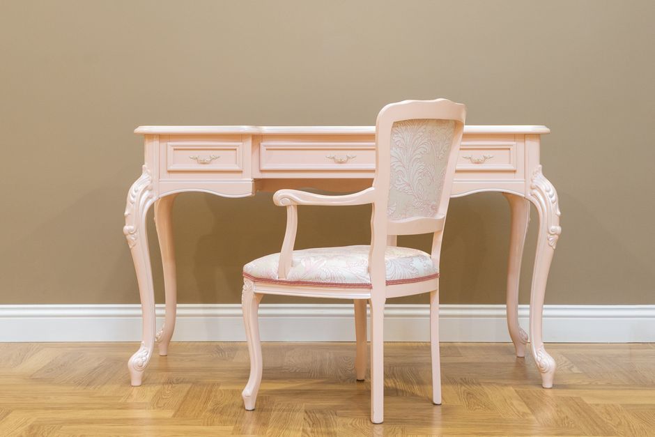 Grandmillennial decor style interior — A classic pink vintage desk and matching chair set on a wooden floor with beige wall, perfect for elegant interiors.