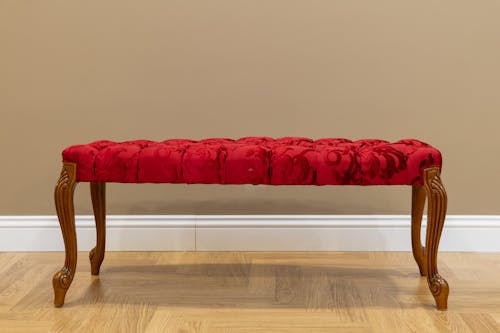 A Red Cushion Chair with Wooden Stand