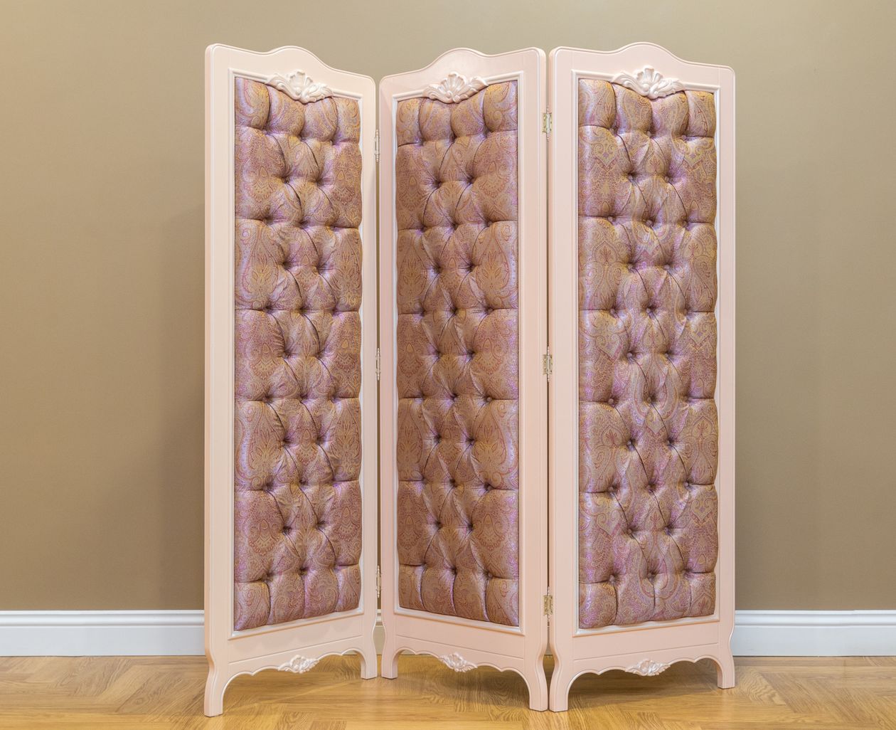 A sheer cream curtain hung from a ceiling track, hiding an open closet from the bedroom area