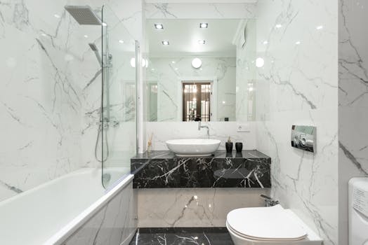 Elegant bathroom with marble decor, featuring bathtub, washbasin, and modern fixtures.