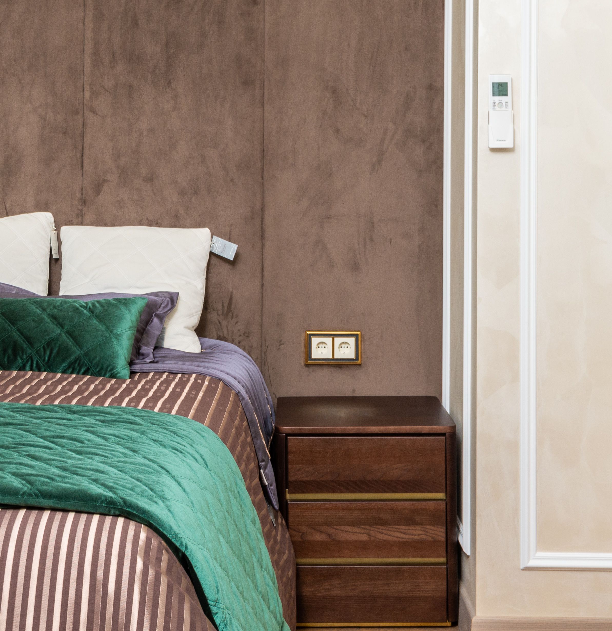 Elegant bedroom featuring a double bed with vibrant bedding and sleek nightstand.