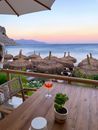 Wooden table placed on terrace behind beach