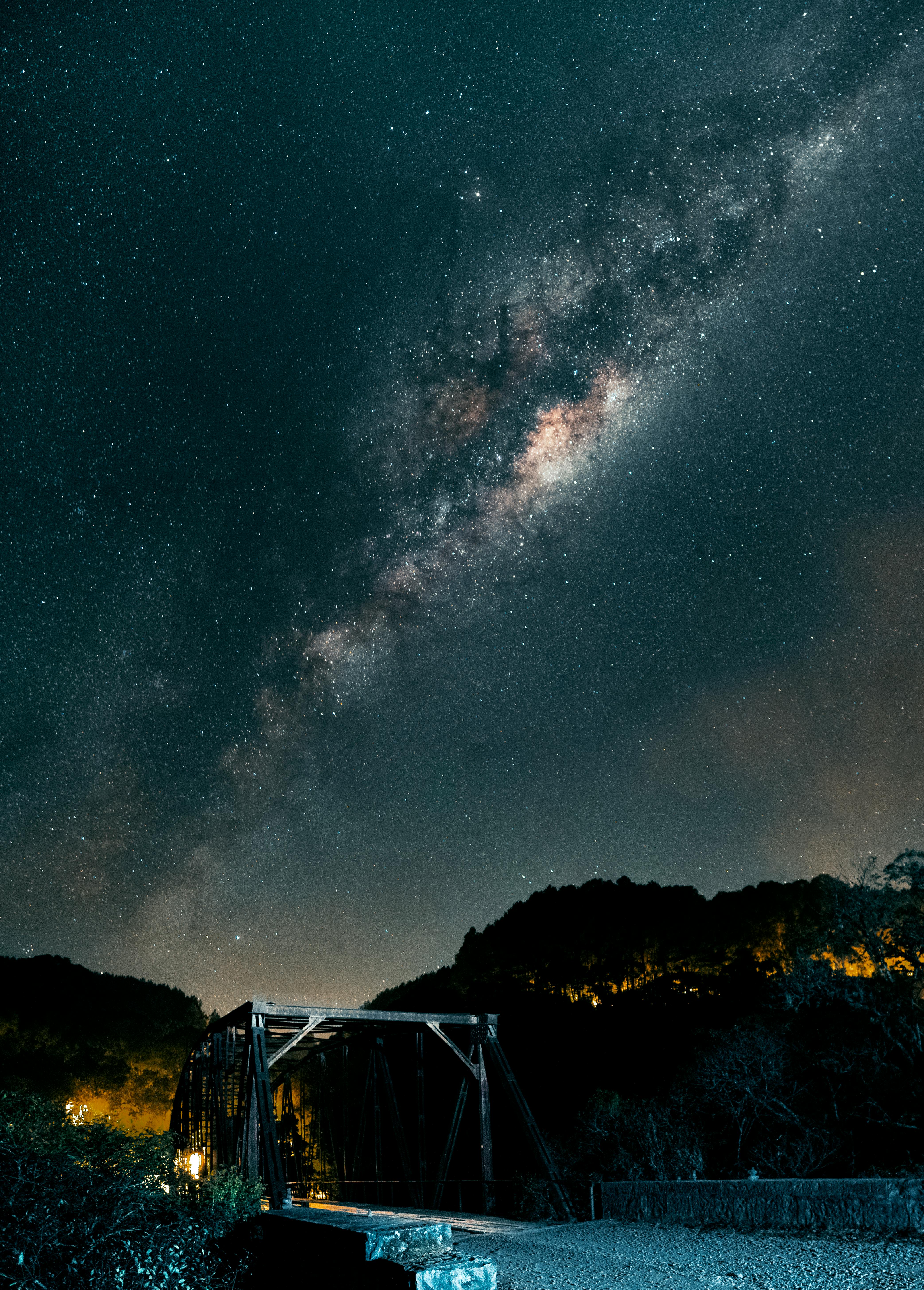Captivating view of the Milky Way above a steel bridge in Canela, Brazil. Perfect for stargazing enthusiasts.