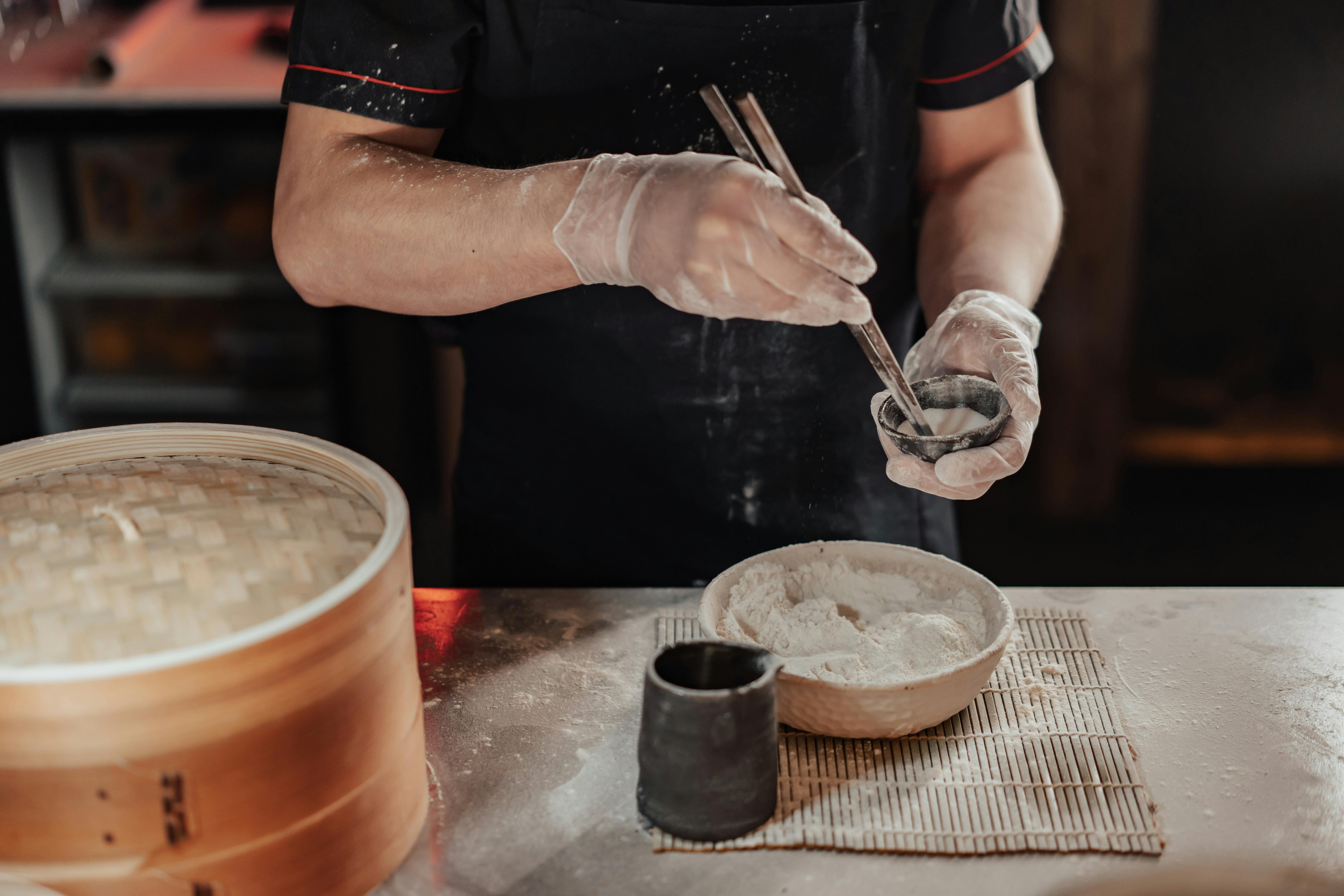 person holding chopsticks mixing flour