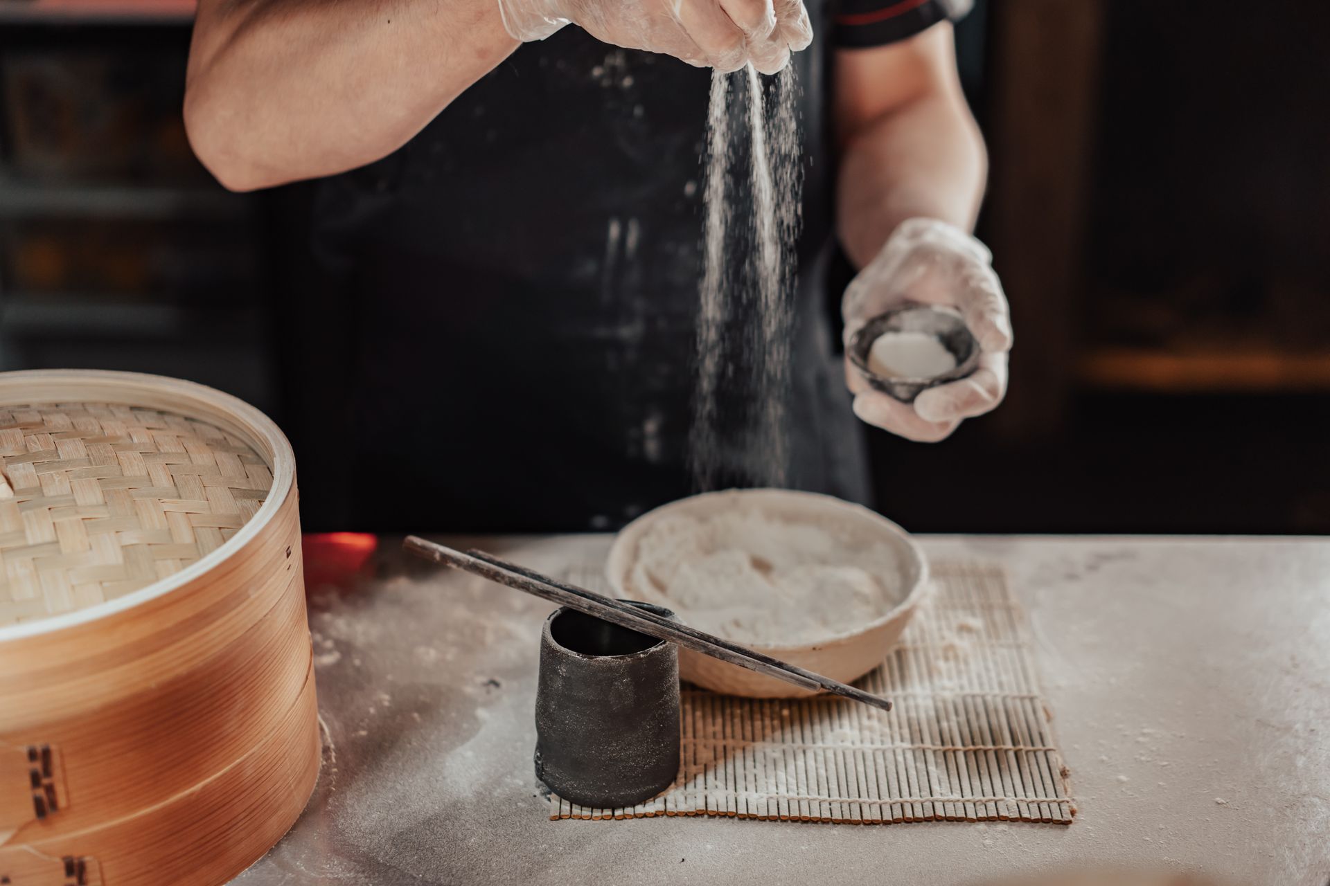 A Person Sprinkles White Powder in to the Bowl