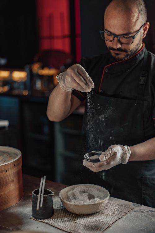 A Chef Sprinkling a Flour · Free Stock Photo