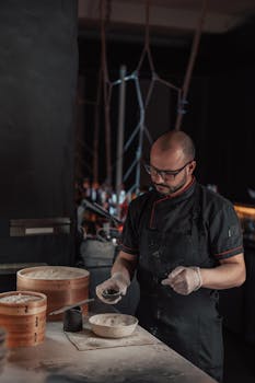 Chef prepares dough for traditional dumplings in an intimate restaurant setting. Skillful culinary process.