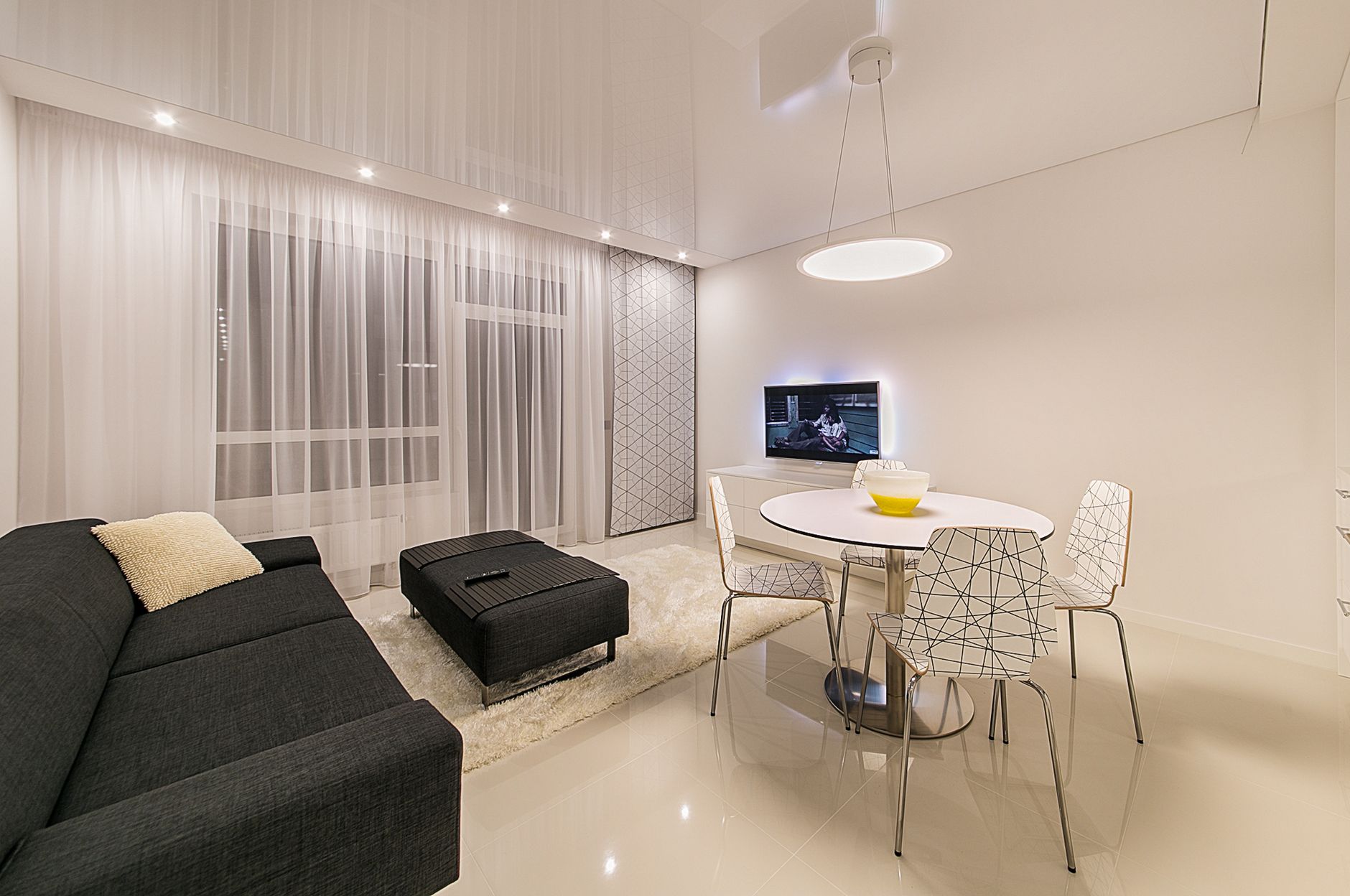 Sleek and stylish living room featuring modern furnishings and elegant lighting.